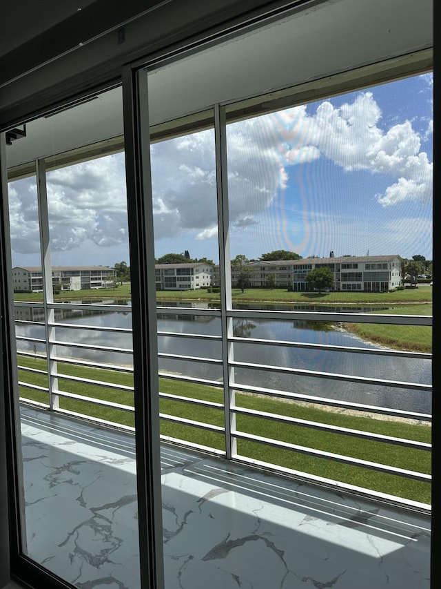 doorway to outside with a water view and plenty of natural light