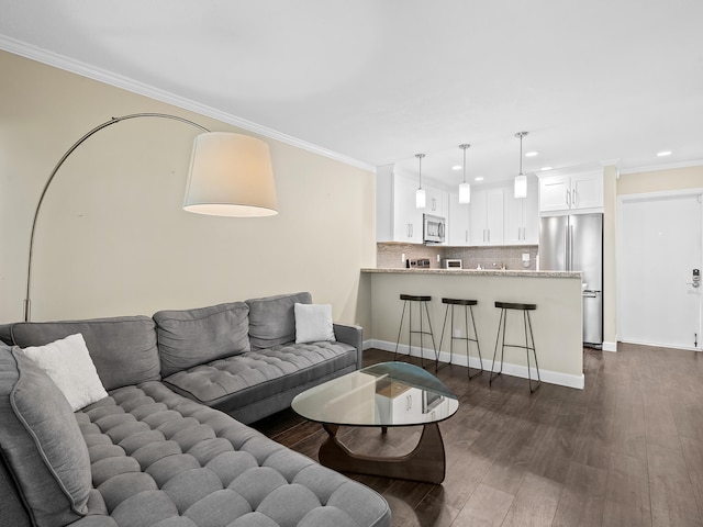 living room featuring ornamental molding and dark hardwood / wood-style flooring