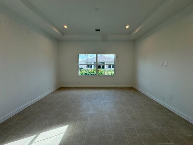 empty room featuring a tray ceiling