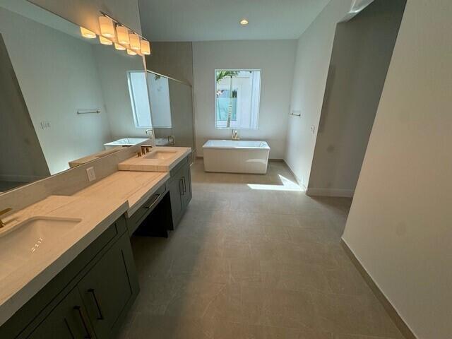 bathroom featuring vanity and a tub