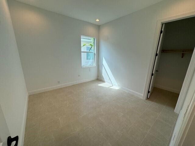 unfurnished bedroom with a closet and a walk in closet