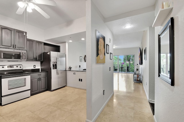 kitchen featuring appliances with stainless steel finishes, a textured ceiling, and ceiling fan