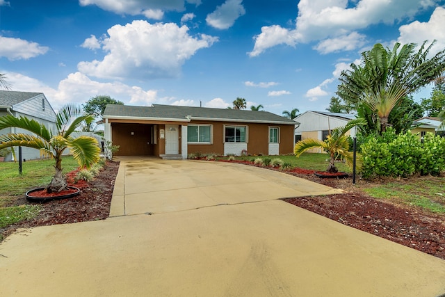 ranch-style house featuring a carport