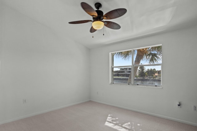 carpeted spare room with ceiling fan