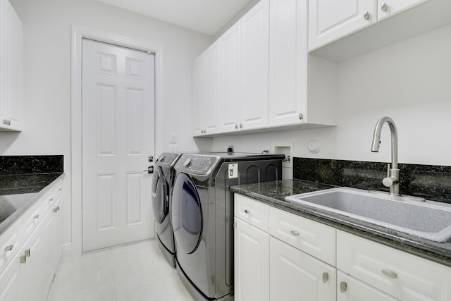 laundry room with cabinets, sink, and washer and dryer