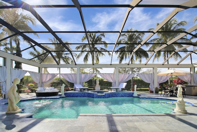 view of swimming pool featuring a lanai, a patio area, and an in ground hot tub