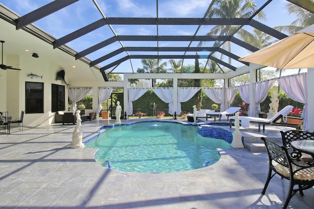 view of swimming pool featuring glass enclosure, pool water feature, and a patio