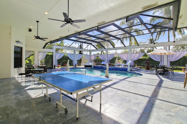 view of pool featuring pool water feature, ceiling fan, a patio area, and a lanai