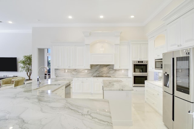 kitchen with sink, crown molding, light stone counters, white cabinetry, and stainless steel appliances