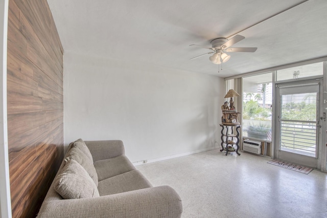 901 N Birch Rd Unit D6, Fort Lauderdale, FL 33304 - living area with a ceiling fan, floor to ceiling windows, baseboards, wooden walls, and a wall mounted air conditioner