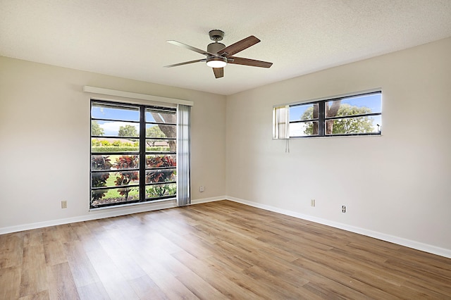 unfurnished room featuring ceiling fan, wood-type flooring, and a textured ceiling