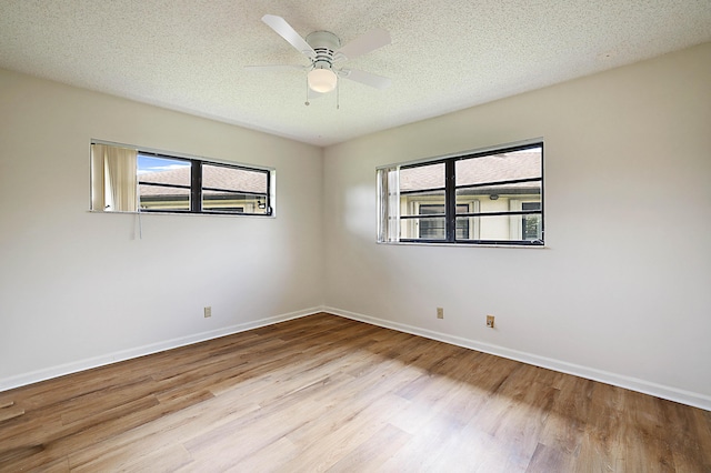 spare room featuring ceiling fan, a textured ceiling, and light wood-type flooring