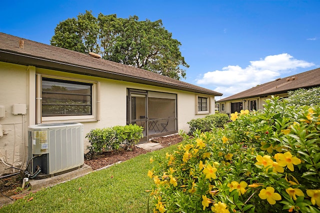 exterior space featuring a yard and central air condition unit