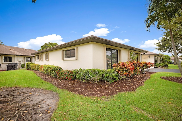 view of side of property with a yard