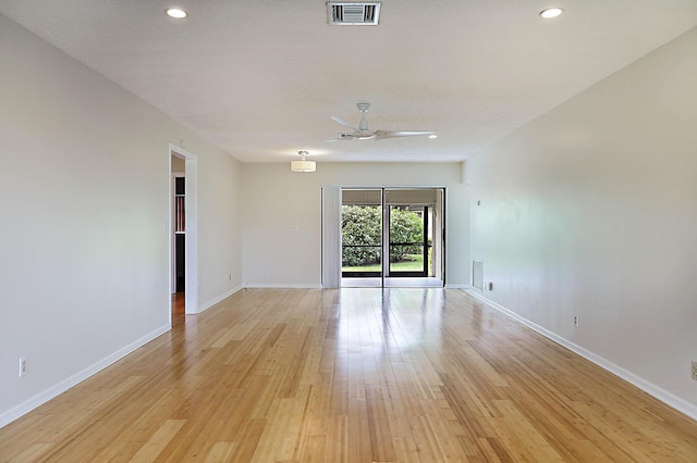 spare room with ceiling fan and light hardwood / wood-style flooring