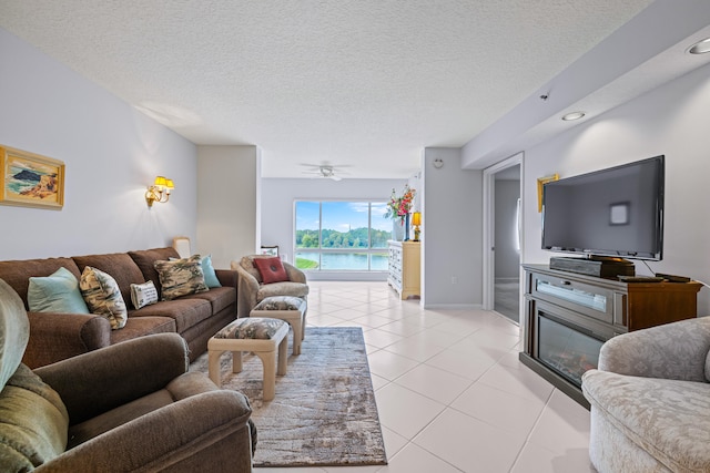 tiled living room featuring ceiling fan and a textured ceiling