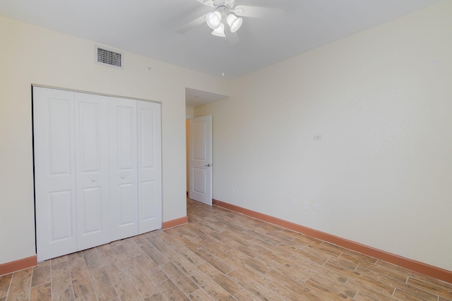 unfurnished bedroom with ceiling fan and a closet