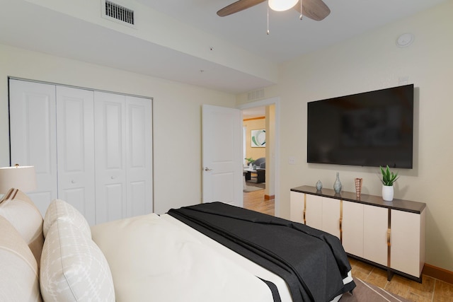 bedroom featuring a closet, ceiling fan, and light wood-type flooring