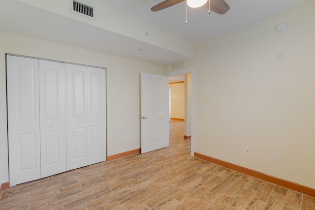 unfurnished bedroom featuring ceiling fan and a closet