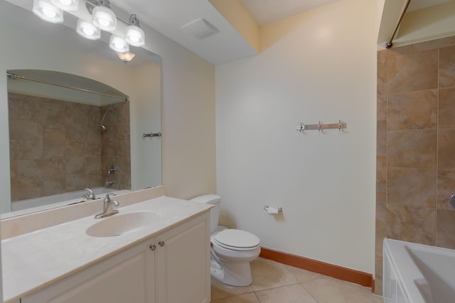 full bathroom with tiled shower / bath, tile patterned floors, toilet, and vanity