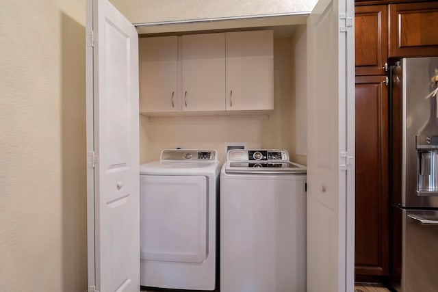 laundry room with cabinets and washer and clothes dryer