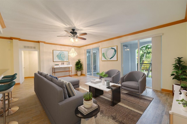 living room with ceiling fan, ornamental molding, and light hardwood / wood-style floors