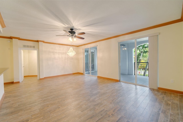 empty room with crown molding, ceiling fan with notable chandelier, and hardwood / wood-style floors