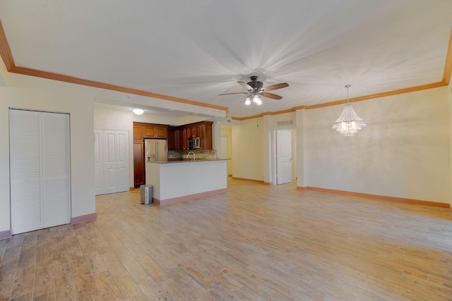 unfurnished living room with ornamental molding, sink, ceiling fan with notable chandelier, and light wood-type flooring