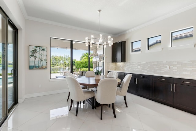 tiled dining space featuring crown molding and a notable chandelier