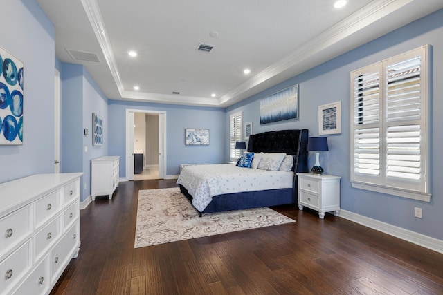 bedroom with dark hardwood / wood-style flooring, crown molding, and a tray ceiling