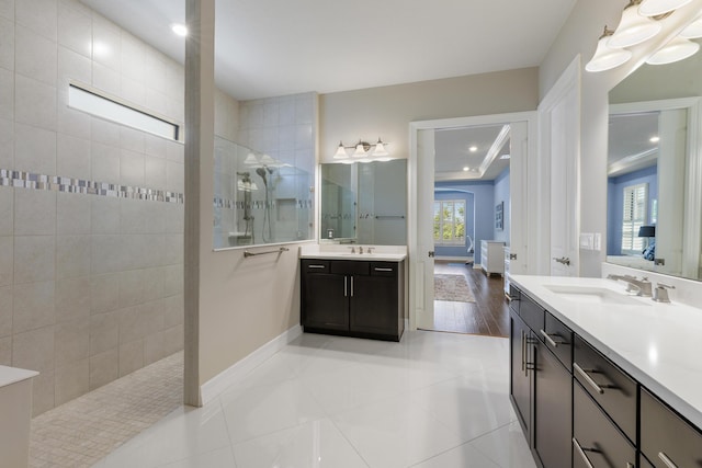 bathroom featuring tile patterned floors, vanity, and tiled shower