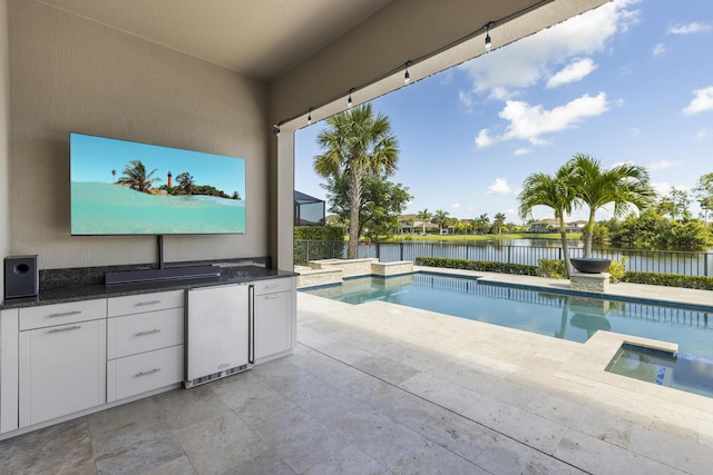 view of swimming pool featuring area for grilling, a patio area, and an in ground hot tub