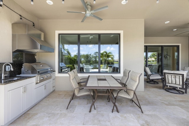 view of patio / terrace featuring area for grilling, ceiling fan, exterior kitchen, and sink