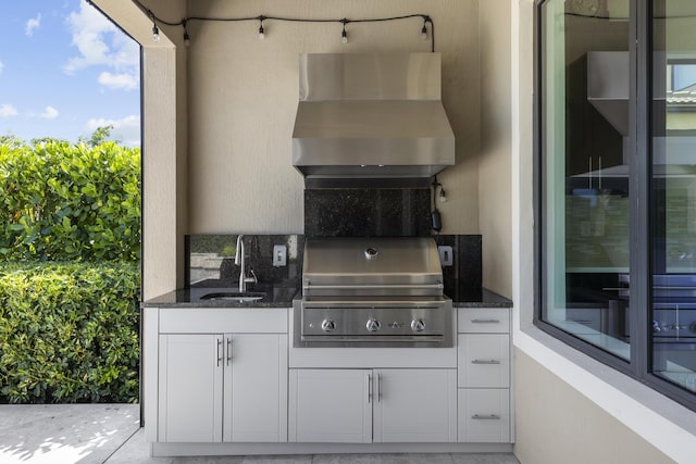 view of patio featuring an outdoor kitchen, grilling area, and sink