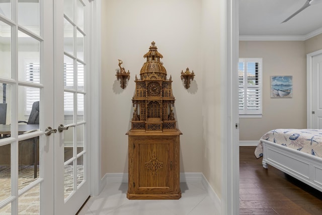 interior space with hardwood / wood-style floors, crown molding, and french doors