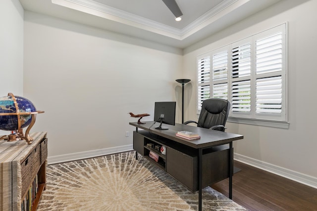 office area with a tray ceiling, crown molding, and dark hardwood / wood-style floors