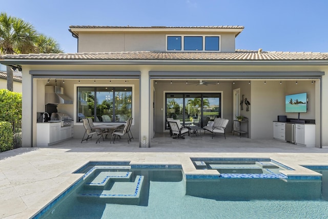 back of house featuring sink, a pool with hot tub, ceiling fan, area for grilling, and a patio area