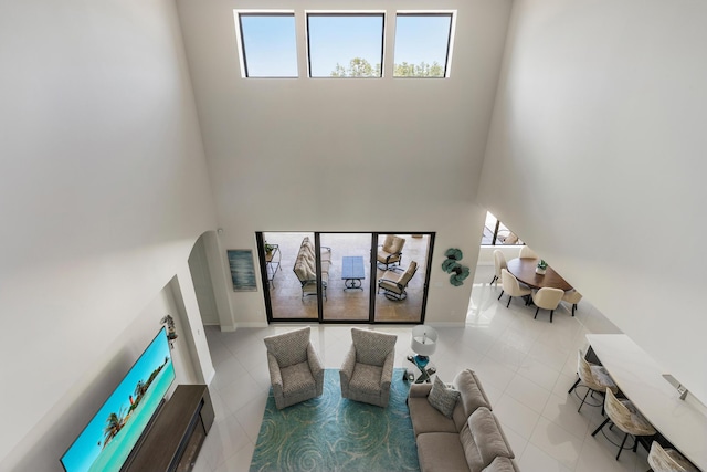 tiled living room with a high ceiling