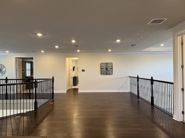 empty room featuring dark hardwood / wood-style floors and ornamental molding