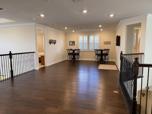 interior space with dark hardwood / wood-style floors and ornamental molding