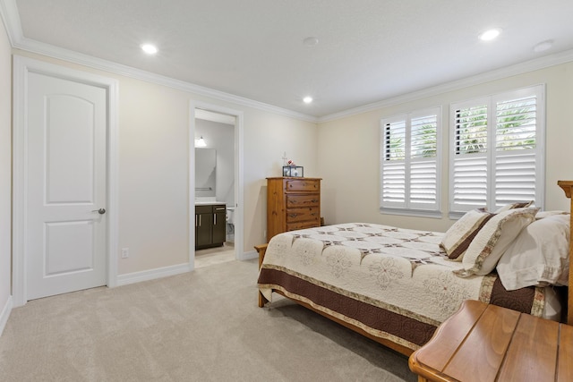 carpeted bedroom with connected bathroom and crown molding