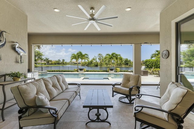 view of patio with an outdoor hangout area, a fenced in pool, ceiling fan, and a water view