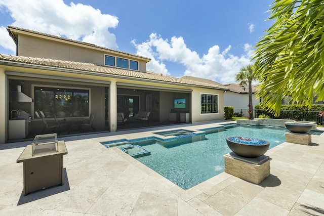 view of swimming pool with an in ground hot tub and a patio area