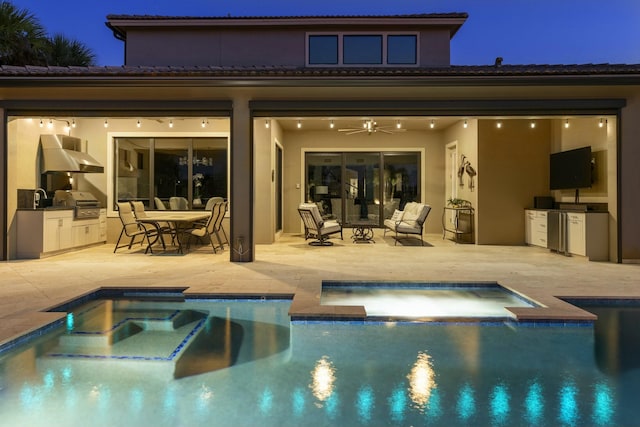 back of house featuring a pool with hot tub, ceiling fan, area for grilling, and a patio area