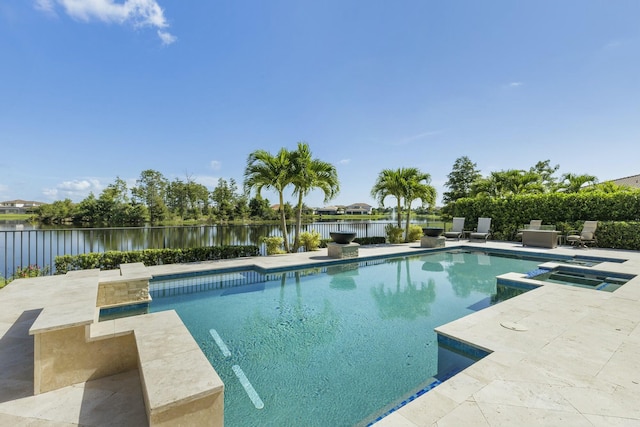 view of swimming pool featuring a water view, an in ground hot tub, and a patio