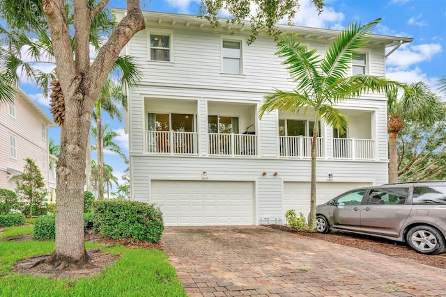 view of front of home featuring a garage and a balcony