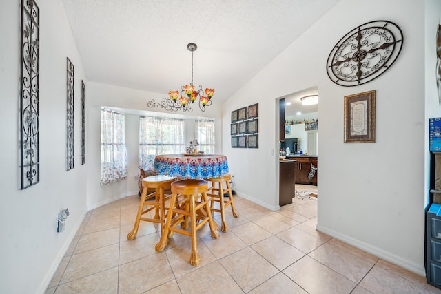 tiled dining room with vaulted ceiling, a textured ceiling, and a chandelier