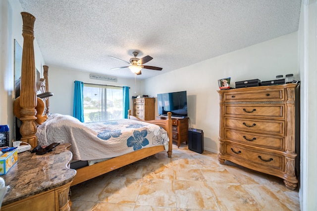 bedroom with a textured ceiling, ceiling fan, and light tile patterned floors