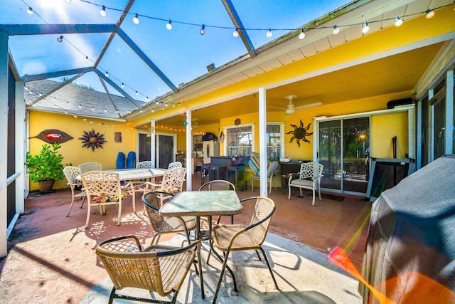 view of patio with ceiling fan and a lanai