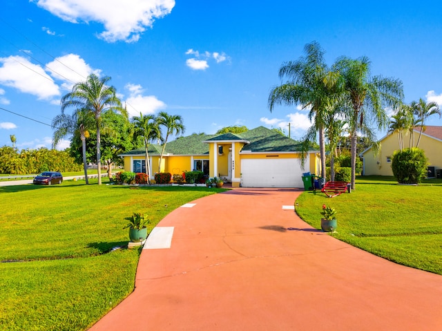 ranch-style home featuring a garage and a front lawn